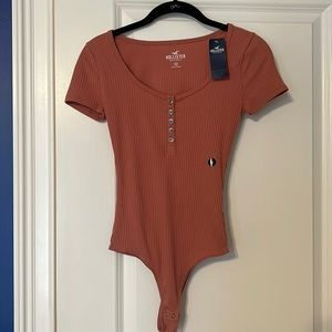 Hollister pink body suit Size XS never worn with tags.